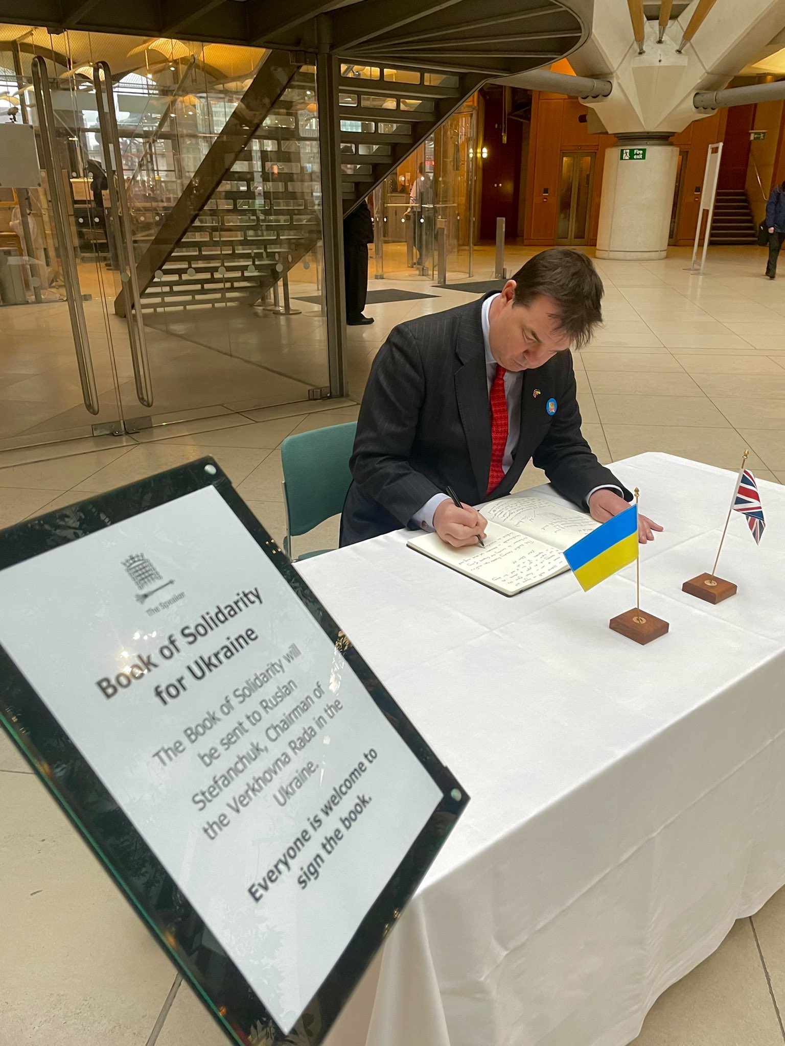 Guy Opperman MP signs a book of solidarity for Ukraine