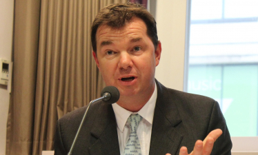 Guy Opperman in front of a microphone